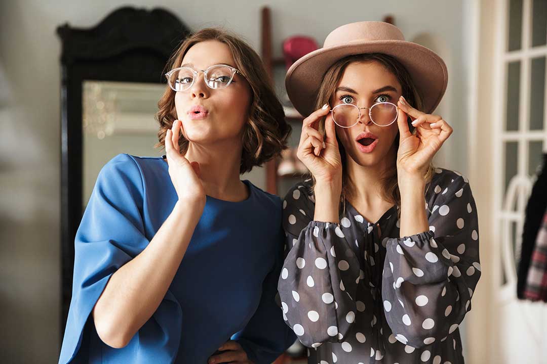 2 ladies trying on glasses