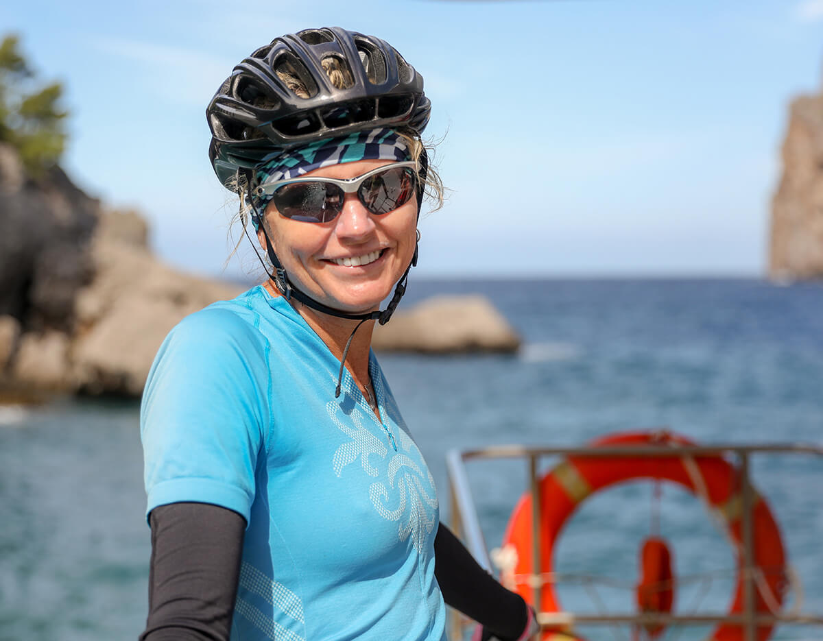 Woman wearing sunglasses and a bike helmet